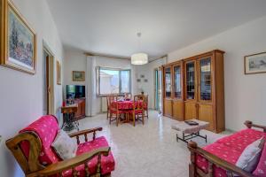 ein Wohnzimmer mit rosa Möbeln und einem Tisch in der Unterkunft La Casa di Guido Hiking Skiing And Lakes - Happy Rentals in Trontano