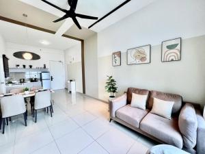 a living room with a couch and a table at New Condo Amber Impression Melaka 2Room6pax1Park in Melaka