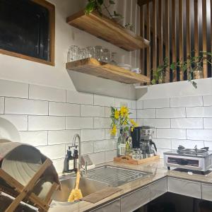 a kitchen counter with a sink and a stove at Casa Maria at Bigang Munti in San Juan