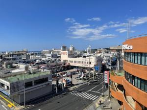 an aerial view of a city with buildings and a street at BiBi Hotel FUTENMA in Ginowan