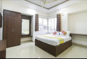 a bedroom with a large bed and a large window at Hotel Ecotel in Nagaon