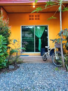 a bike parked in front of a house at Six Nature Resort in Chiang Rai