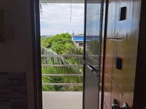 an open door with a view of a balcony at Casa Kristar in Mamburao