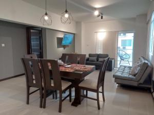 a dining room and living room with a table and chairs at Luxury Apartment -3 bedrooms in Santa Cruz de la Sierra
