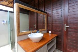 a bathroom with a sink and a mirror at Island Cabanas Formerly Taman Sari Villa in Nusa Lembongan +33 photos