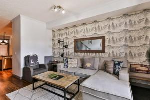 a living room with a couch and a table at Mystic Chalet hosted by Fenwick Vacation Rentals in Canmore