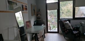 a room with a desk and a chair and windows at Studio Cozy Grant in Bucharest