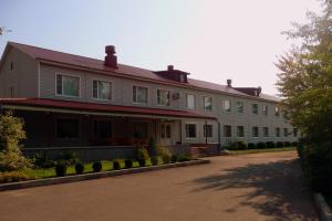 a large white building with a lot of windows at Gostinica Garmnonia Plus in Velikiye Luki