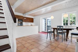 a kitchen and dining room with a table and chairs at Sndergade 5, rskbing in Ærøskøbing