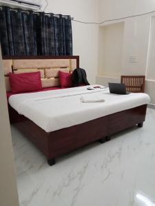 a bedroom with a bed with a laptop on it at OYO Zora Luxury Rooms in Visakhapatnam