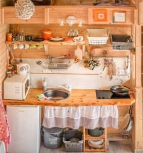 a kitchen with a wooden counter with a sink at Tiny House Lavender in Podtureň