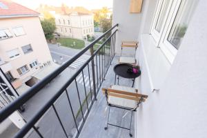 balcone con 2 sedie e un tavolo di Soho Boutique Apartman a Požega