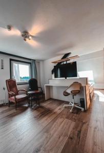 a living room with two chairs and a tv at Hotel Bergsonne Rigi in Rigi Kaltbad