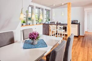 cocina y comedor con mesa blanca y sillas en Landgut Mosch en Radeburg