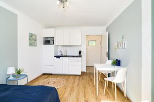 een slaapkamer met een bed en een keuken met een tafel bij Ruhige Oase in der Nähe von Parkanlage und Krankenhaus in Graz