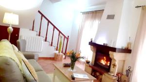 a living room with a couch and a fireplace at One bedroom villa with furnished garden and wifi at Camacha in Camacha