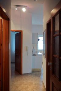 a hallway with a door leading to a kitchen at Ferienwohnung blaues Haus in Bischofsheim an der Rhön