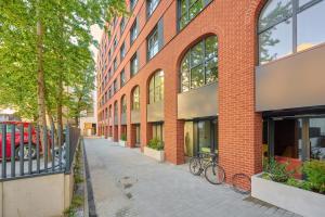 a brick building with two bikes parked in front of it at Lux Apartment Plac Wolności 6 in Poznań Old Town by Renters Prestige in Poznań