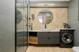 a bathroom with a washing machine and a sink at Lux Apartment Plac Wolności 6 in Poznań Old Town by Renters Prestige in Poznań