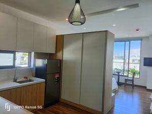 a kitchen with a stainless steel refrigerator and a sink at Tree Homestay in Da Nang