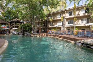 a swimming pool in front of a hotel at Ramada Spacious Studio Apartment with Pool Views in Port Douglas