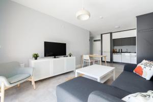 a living room with a couch and a tv at Luminous Flat 7 min to Arcadium Mall in Ankara in Ankara