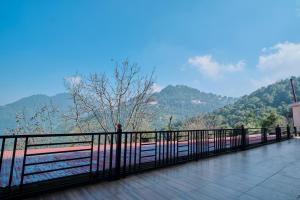 a train on a bridge with a view of a mountain at Trideus Chandseena Valley Resort in Mussoorie