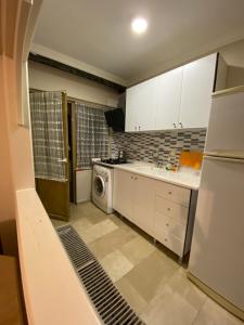 A kitchen or kitchenette at EVİM APART HOTEL