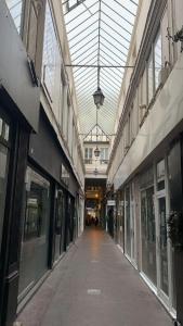 an empty hallway in a building with a glass ceiling at 21 Atelier Chaplin Montorgueil in Paris