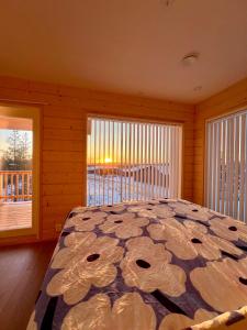 a bedroom with a bed with a view of a deck at Villa Golden House in Rovaniemi
