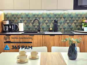 a kitchen with a table with a vase on it at 365PAM - Apartament Leaf 6-osobowy in Ustronie Morskie