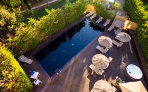 an overhead view of a swimming pool with tables and chairs at Black Hotel in Rome