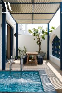 un patio con una mesa y una piscina en Apple Hause Venuestay, en Phan Rang
