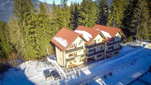 an aerial view of a house in the snow at Holiday Vila Predeal in Predeal
