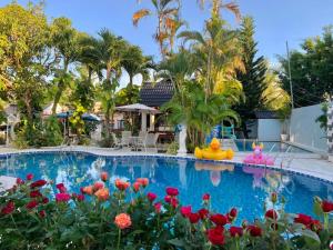 a swimming pool with a rubber duck in a garden at Godiva Villa Phu Quoc in Phú Quốc