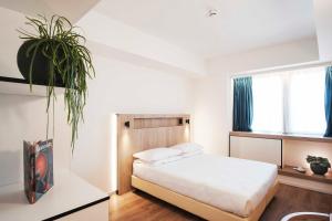 Postel nebo postele na pokoji v ubytování Aparthotel Colombo Roma