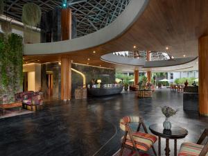 a lobby of a hotel with a table and chairs at Wyndham Grand Nai Harn Beach Phuket in Nai Harn Beach