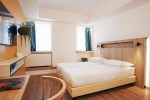 Postel nebo postele na pokoji v ubytování Aparthotel Colombo Roma