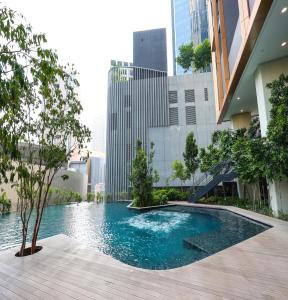 a swimming pool in the middle of a building at Lucentia Residence At Kuala Lumpur By Dreamcloud in Kuala Lumpur