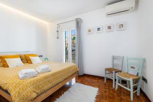 a bedroom with a bed and a chair at Varadero in Portocolom