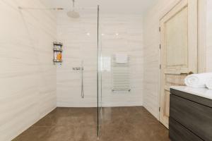 a bathroom with a shower with a glass door at Villa Casablanca in Braşov