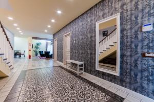 a hallway with a blue and white wall with a staircase at Villa Casablanca in Braşov