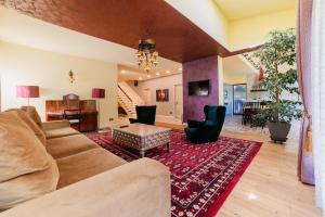 a living room with a couch and a table at Villa Casablanca in Braşov