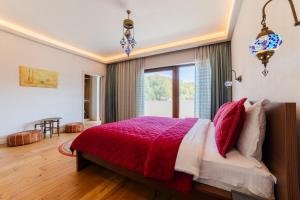 a bedroom with a bed and a large window at Villa Casablanca in Braşov