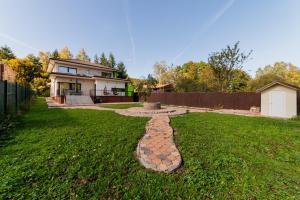 a backyard with a stone fountain in the grass at Villa Casablanca in Braşov