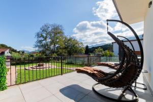 a wicker chair on a patio with a view of a park at Villa Casablanca in Braşov