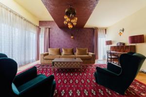 a living room with a couch and a table at Villa Casablanca in Braşov