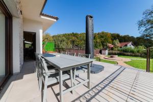 a patio with a table and chairs on a deck at Villa Casablanca in Braşov +23 photos