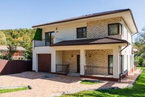 a house with a driveway in front of it at Villa Casablanca in Braşov