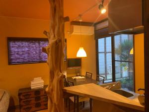 a kitchen with a wooden tree in the corner of a room at SAKARA KYOTO 桜香楽 京都 in Kyoto
